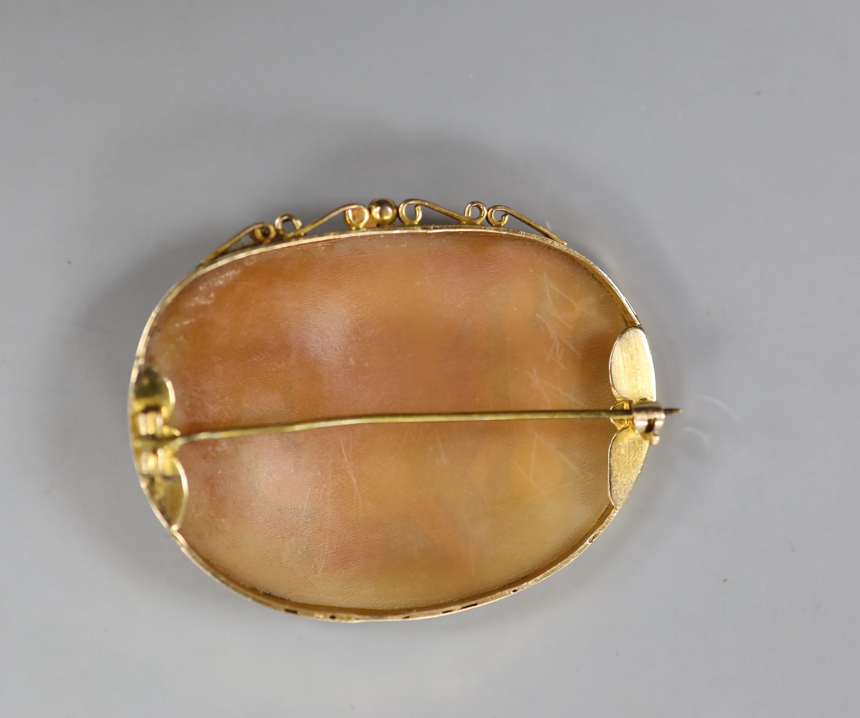 A 9ct mounted oval cameo brooch, carved with Cupid & Psyche, 60mm, gross weight 17.9 grams.